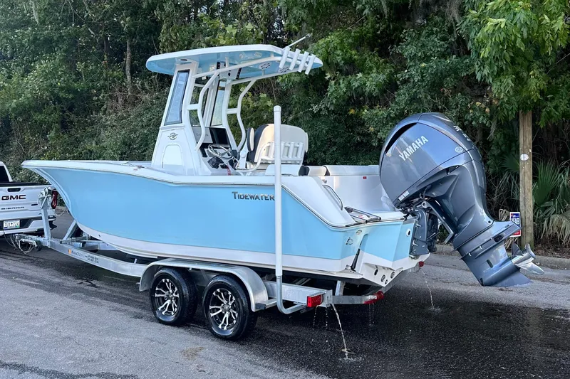 Slide: The Image of 2023 Tidewater 232 LXF boat on trailer with Yamaha engine, parked outdoors. - 13