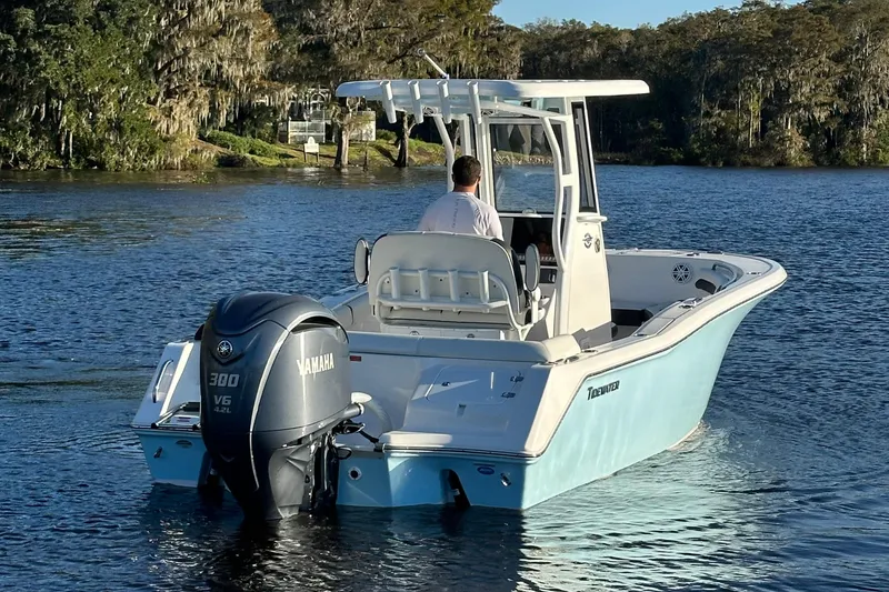 Slide: The Image of 2023 Tidewater 232 LXF boat with Yamaha engine on a serene lake. - 3