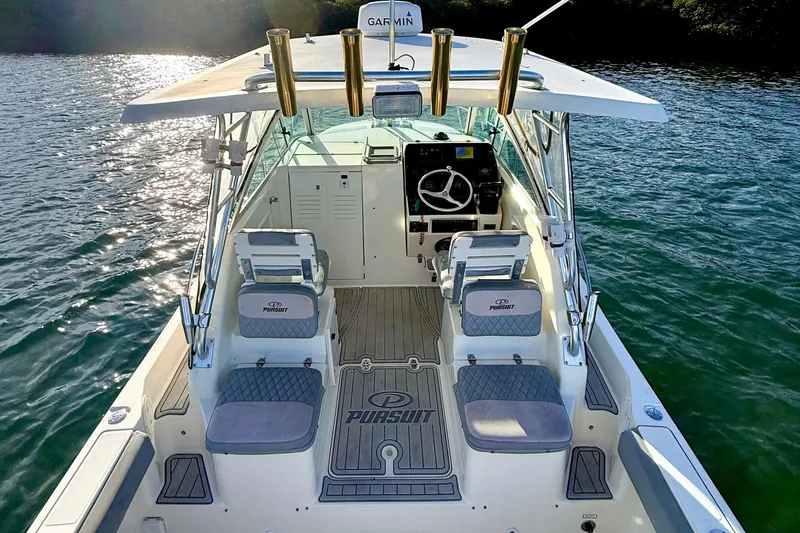 Slide: The Image of 2003 Pursuit 2870 Walkaround boat interior with helm, seating, and ocean view. - 13