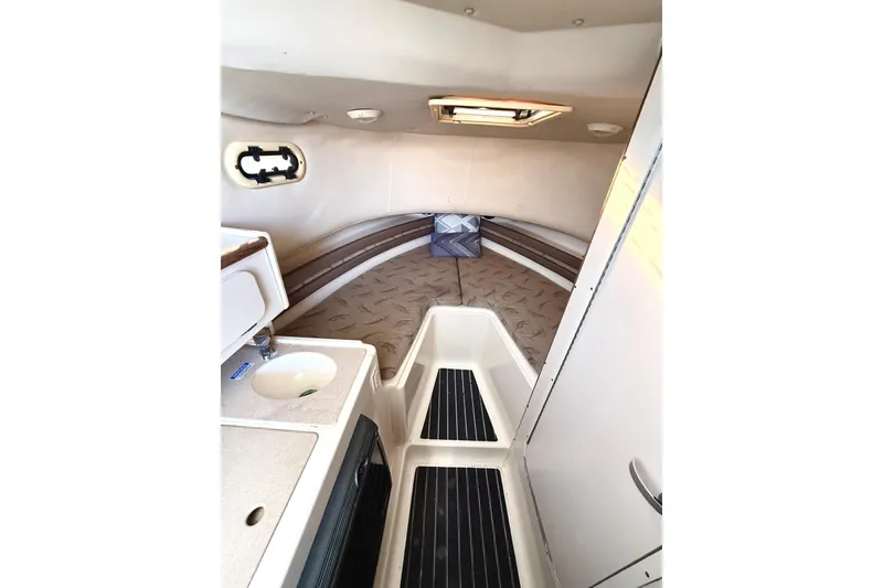 Slide: The Image of 2003 Pursuit 2870 Walkaround cabin interior with sink and bed. - 19