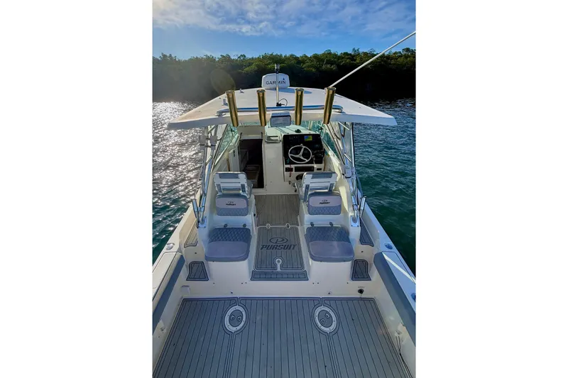 Slide: The Image of 2003 Pursuit 2870 Walkaround boat interior with helm, seats, and ocean backdrop. - 6