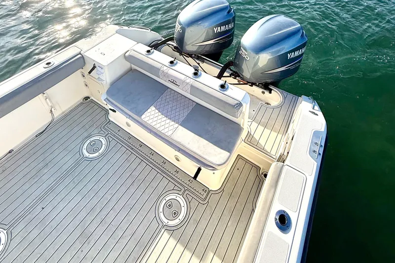 Slide: The Image of 2003 Pursuit 2870 Walkaround boat with twin Yamaha engines on water. - 9