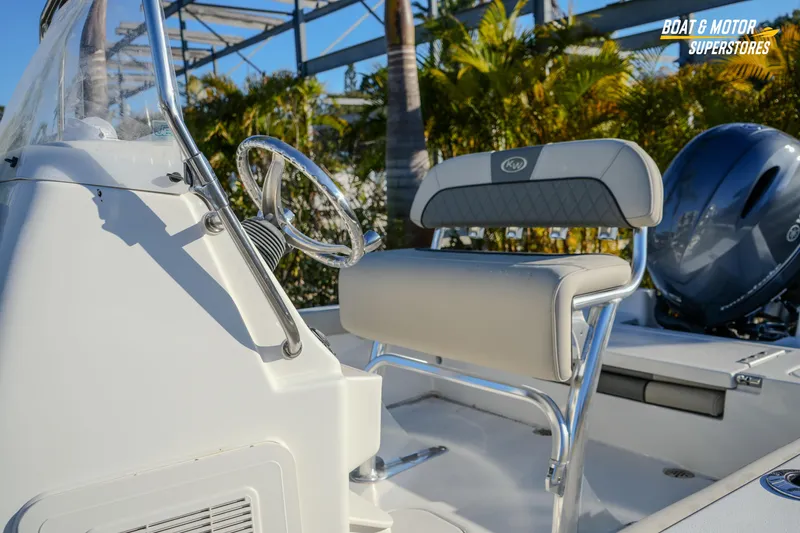 Slide: The Image of 2026 Key West 188 Bay Reef boat interior with steering wheel and seating. - 10