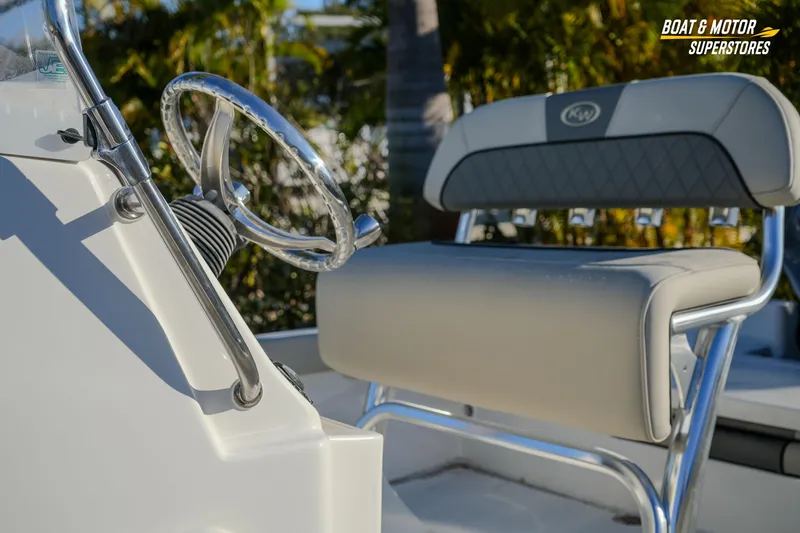 Slide: The Image of 2026 Key West 188 Bay Reef boat interior with steering wheel and seating. - 11