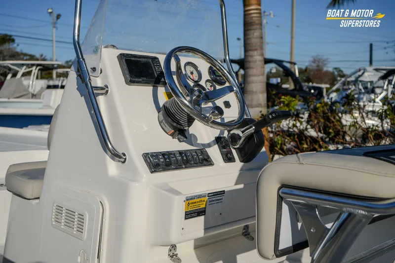 Slide: The Image of 2026 Key West 188 Bay Reef boat dashboard with steering wheel and controls. - 15