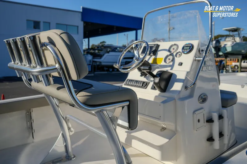 Slide: The Image of 2026 Key West 188 Bay Reef boat interior with steering console and seating. - 23