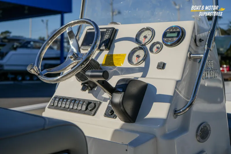 Slide: The Image of 2026 Key West 188 Bay Reef boat dashboard with steering wheel and gauges. - 24