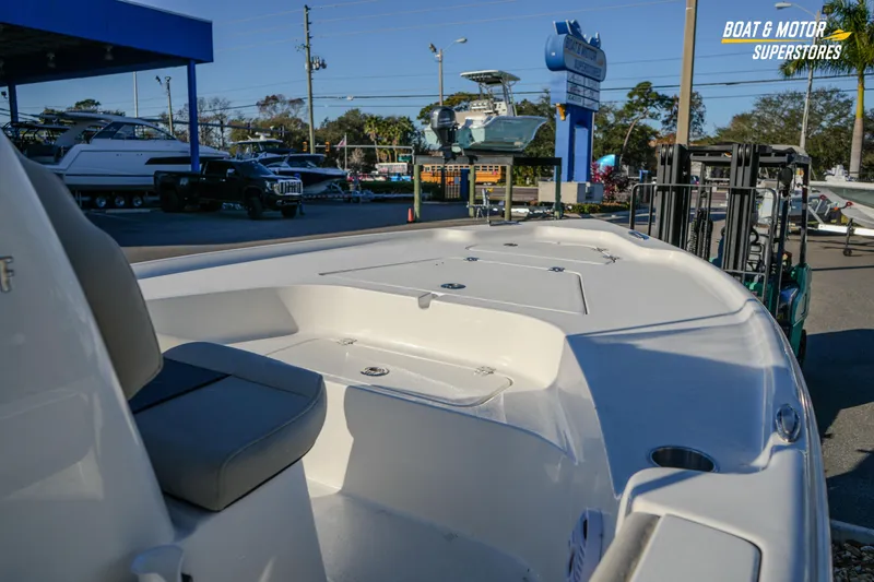 Slide: The Image of 2026 Key West 188 Bay Reef boat displayed at dealership, showcasing sleek design and seating. - 27