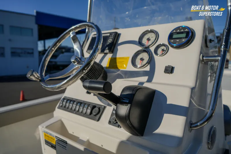 Slide: The Image of 2026 Key West 188 Bay Reef boat dashboard with steering wheel and gauges. - 31
