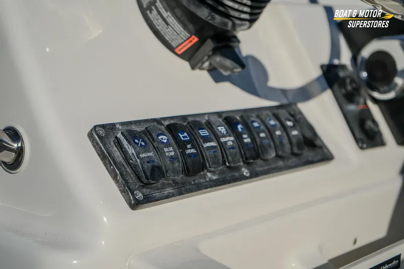 Slide: The Image of Control panel of 2026 Key West 188 Bay Reef boat with labeled switches. - 32