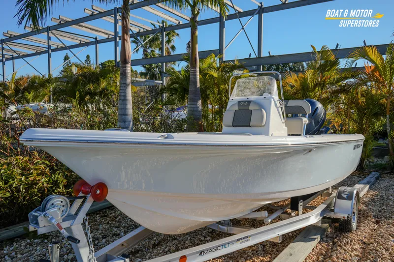 Slide: The Image of 2026 Key West 188 Bay Reef boat on trailer, surrounded by tropical plants. - 4