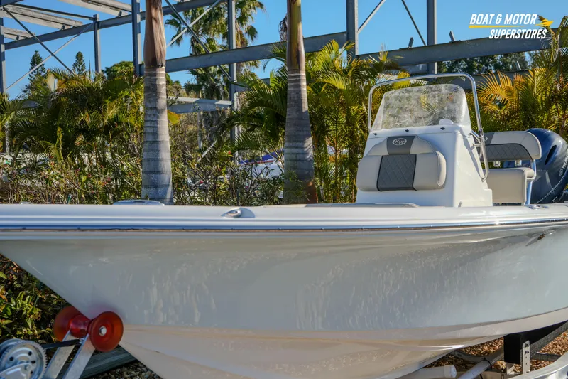 Slide: The Image of 2026 Key West 188 Bay Reef boat on trailer, surrounded by tropical plants. - 5