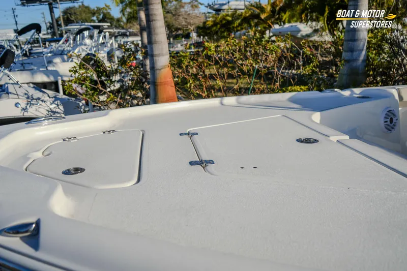 Slide: The Image of 2026 Key West 188 Bay Reef boat deck with storage compartments, displayed at a dealership. - 6