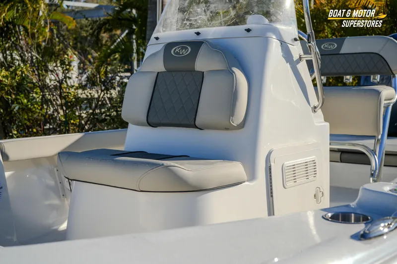 Slide: The Image of 2026 Key West 188 Bay Reef boat interior with cushioned seating and console. - 9