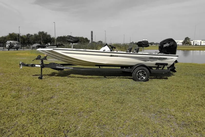 Slide: The Image of 2026 Ranger RT188 boat on trailer, parked on grass near water. - 3