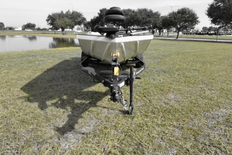 Slide: The Image of 2026 Ranger RT188 boat on trailer, parked on grassy area near a pond. - 1