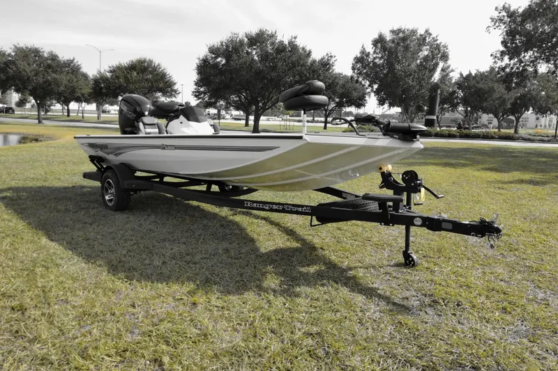 The Image of 2026 Ranger RT188 boat on trailer, parked on grass with trees in background. - 0