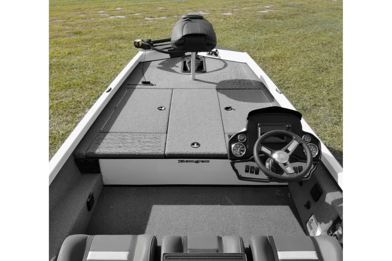 Slide: The Image of 2026 Ranger RT188 boat interior with steering wheel and seating on grassy background. - 8