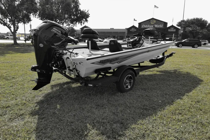 Slide: The Image of 2026 Ranger RT188 boat on trailer, parked on grass near Outdoor World store. - 6