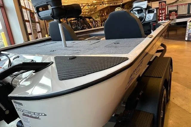 The Image of 2026 Tracker Savage 215 boat displayed indoors, featuring sleek design and comfortable seating. - 0
