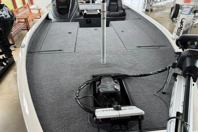 Slide: The Image of 2026 Tracker Savage 215 boat interior with Garmin trolling motor and spacious deck. - 11