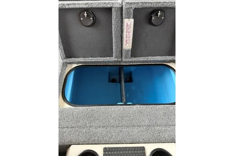 Slide: The Image of 2026 Tracker Savage 215 boat interior storage compartment with blue lining. - 18