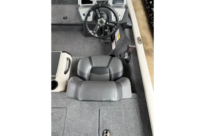 Slide: The Image of Interior of 2026 Tracker Savage 215 boat with steering wheel and seat. - 10