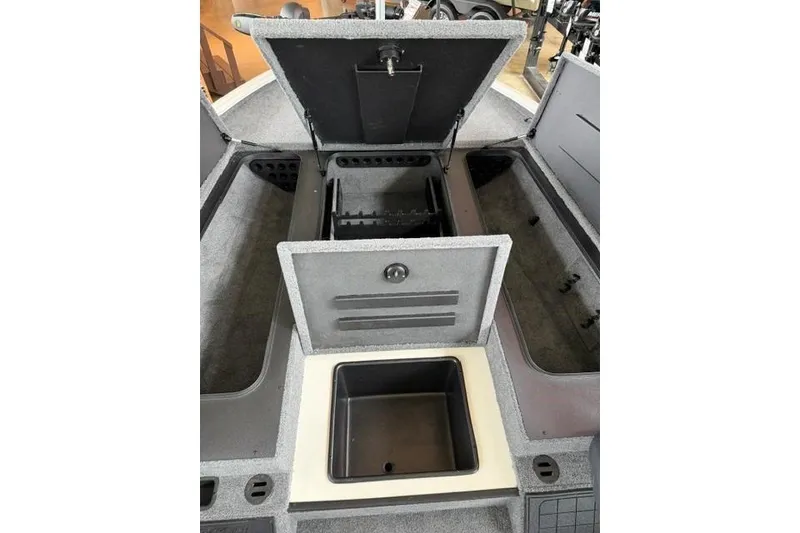 Slide: The Image of 2026 Tracker Savage 215 boat interior storage compartments open for viewing. - 17