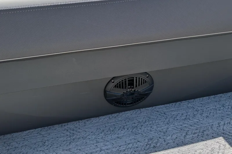 Slide: The Image of 2026 Sun Tracker Fishin' Barge 22 XP3 speaker detail on carpeted deck. - 13