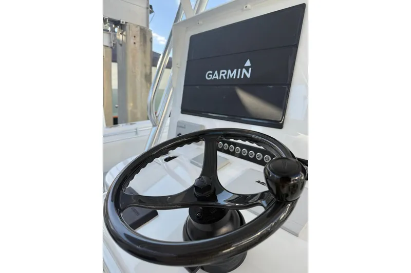 Slide: The Image of 2024 Contender 44 ST boat interior with modern seating and navigation system at marina. - 10