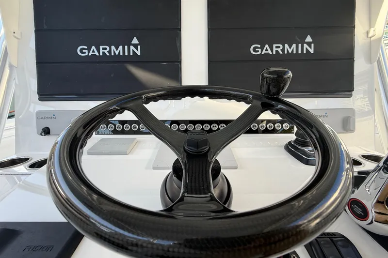 Slide: The Image of Steering wheel of 2024 Contender 44 ST boat with Garmin navigation displays. - 14