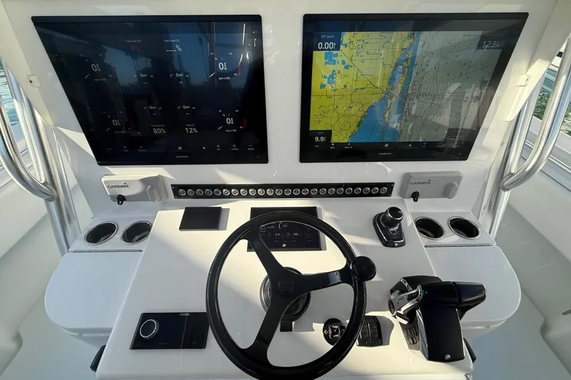 Slide: The Image of 2024 Contender 44 ST helm with dual Garmin displays and advanced navigation controls. - 16