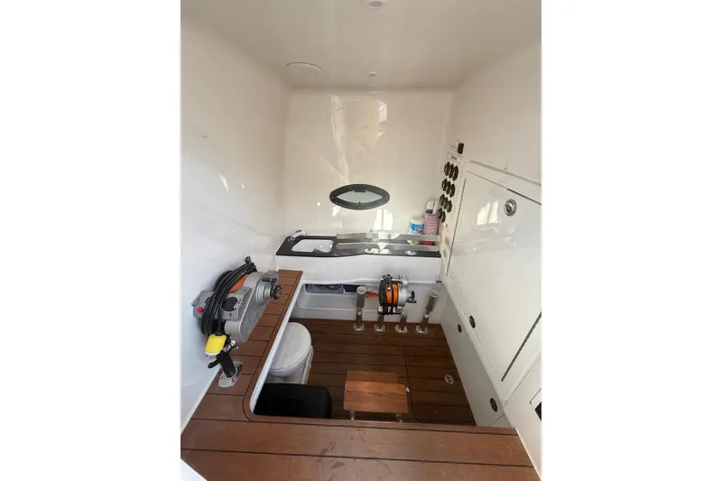 Slide: The Image of 2024 Contender 44 ST boat interior with wooden flooring and fishing equipment. - 17