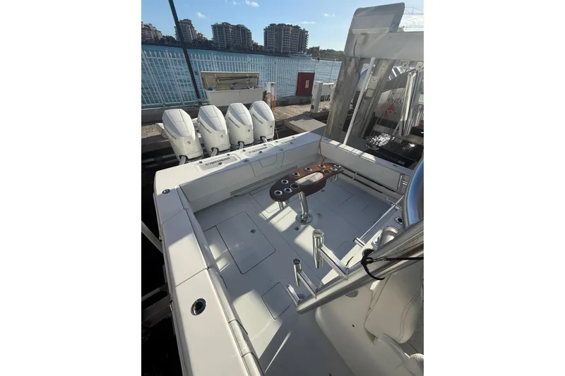 Slide: The Image of 2024 Contender 44 ST boat docked at marina, view from helm with Garmin equipment. - 4