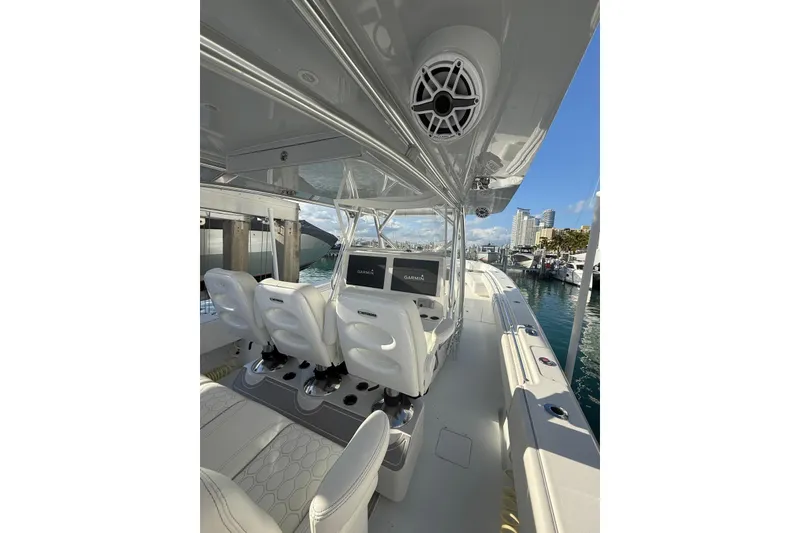 Slide: The Image of 2024 Contender 44 ST boat with rod holders and Mercury engines at dock. - 8