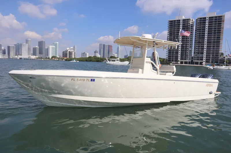 The Image of 2002 Intrepid 289 Open boat in front of city skyline with skyscrapers. - 0