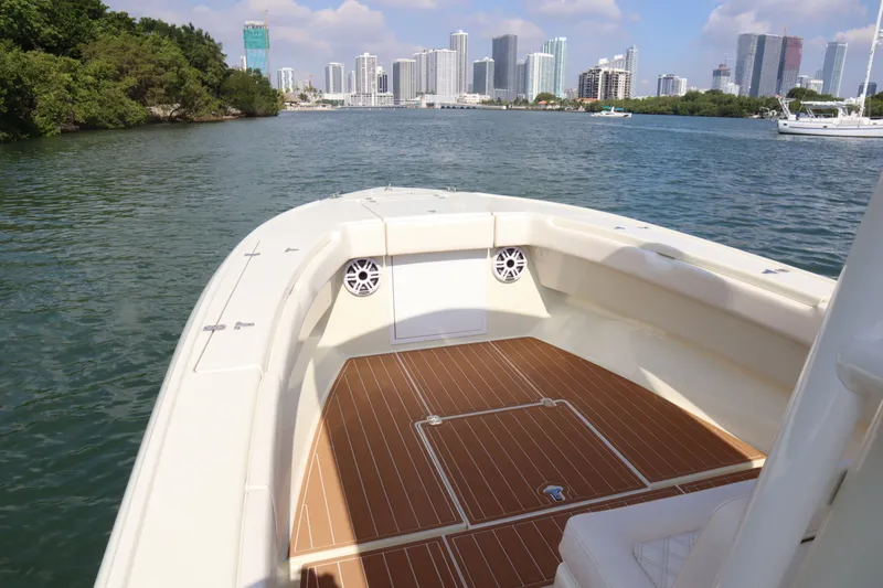 Slide: The Image of Intrepid 289 Open boat with city skyline in background, year 2002. - 11