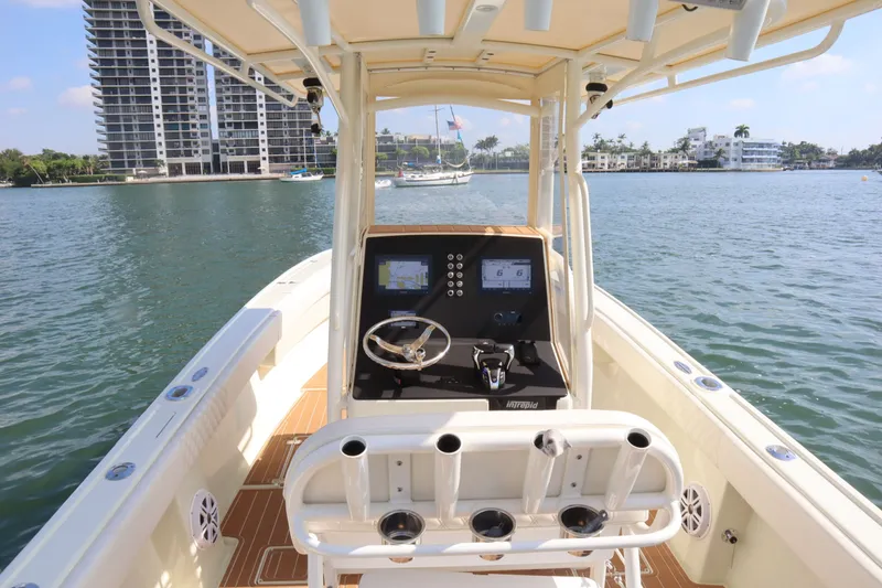 Slide: The Image of Intrepid 289 Open 2002 on calm water with city view. - 14