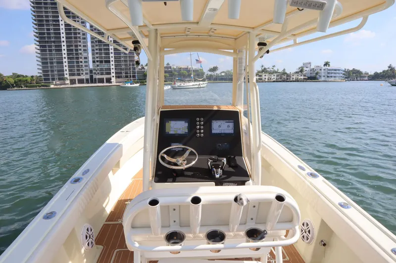 Slide: The Image of Intrepid 289 Open 2002 boat on water with city view. - 15