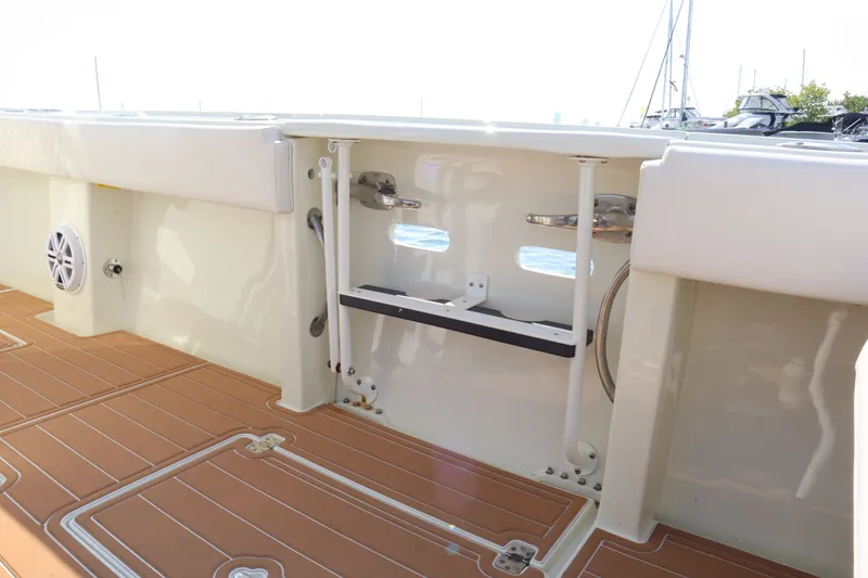 Slide: The Image of Intrepid 289 Open 2002 boat deck with wood flooring and speaker. - 19