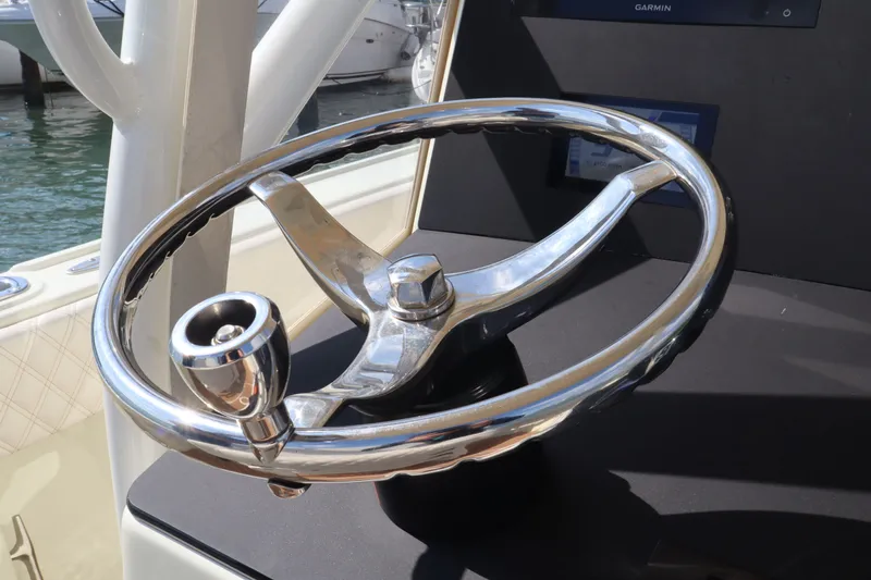 Slide: The Image of Steering wheel of a 2002 Intrepid 289 Open boat in sunlight. - 25