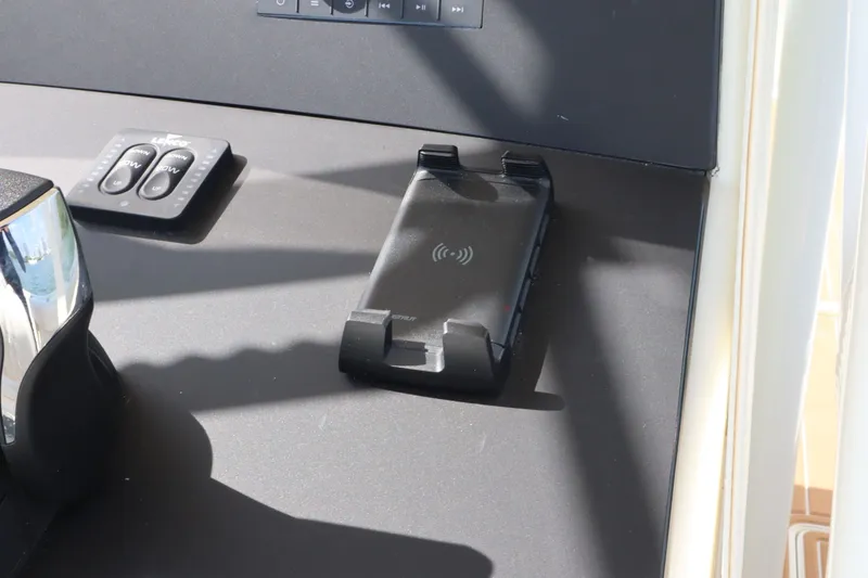 Slide: The Image of Intrepid 289 Open 2002 boat console with controls and charger. - 26