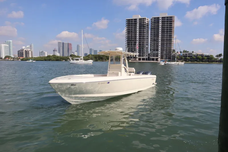 Slide: The Image of 2002 Intrepid 289 Open boat on water with city skyline. - 3
