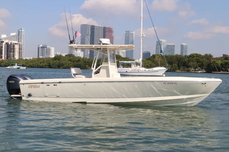 Slide: The Image of 2002 Intrepid 289 Open boat on water with city skyline. - 6