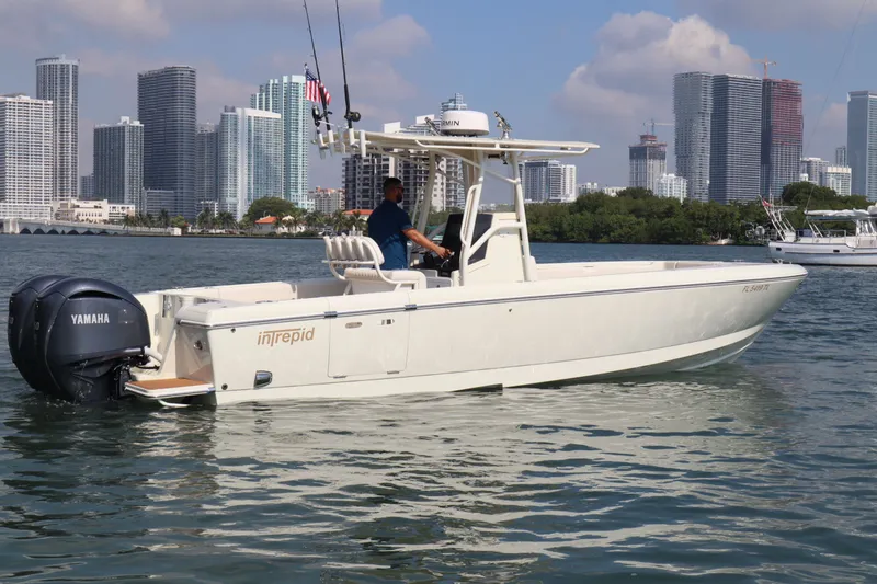 Slide: The Image of 2002 Intrepid 289 Open boat on water with city skyline. - 7