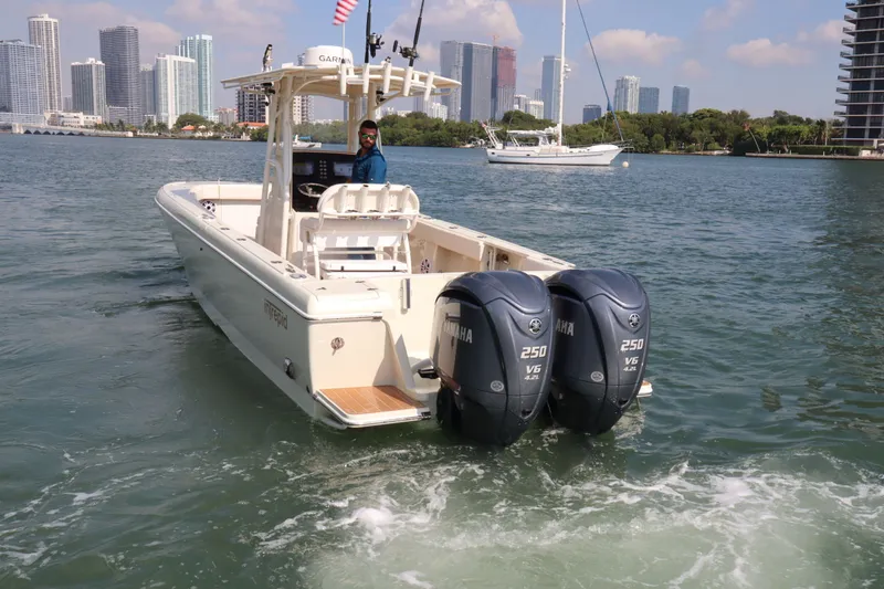 Slide: The Image of 2002 Intrepid 289 Open boat on water with city skyline background. - 9