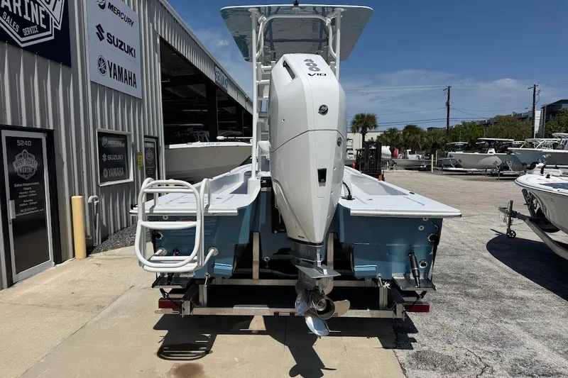 Slide: The Image of 2026 Shallow Sport 25 X3 boat with powerful outboard motor at a marine dealership. - 14