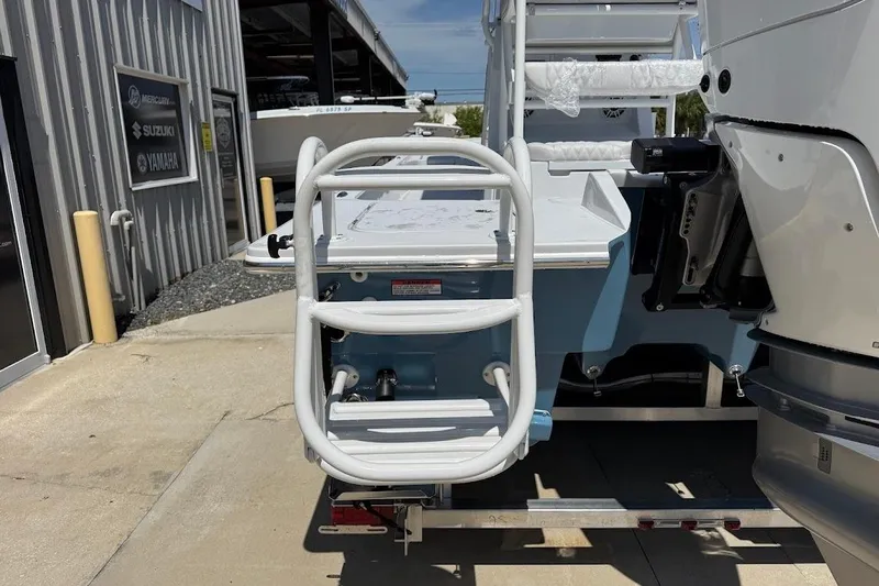 Slide: The Image of Rear view of 2026 Shallow Sport 25 X3 boat with ladder and engine. - 16