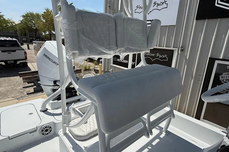 Slide: The Image of 2026 Shallow Sport 25 X3 boat with Mercury engine, featuring cushioned seating. - 19
