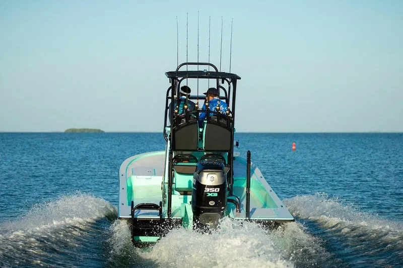 Slide: The Image of Manufacturer Provided Image: 2025 Shallow Sport 25 X3 boat cruising on open water, rear view. - 2